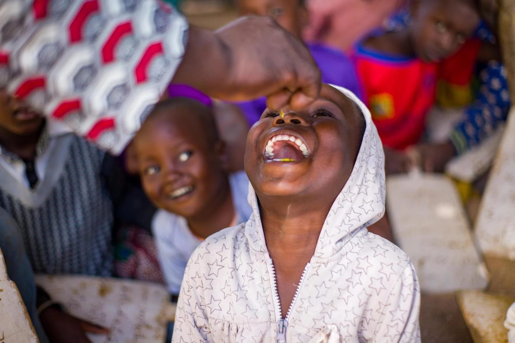 A health worker gives a young child a dose of vitamin A during a campaign in Cameroon